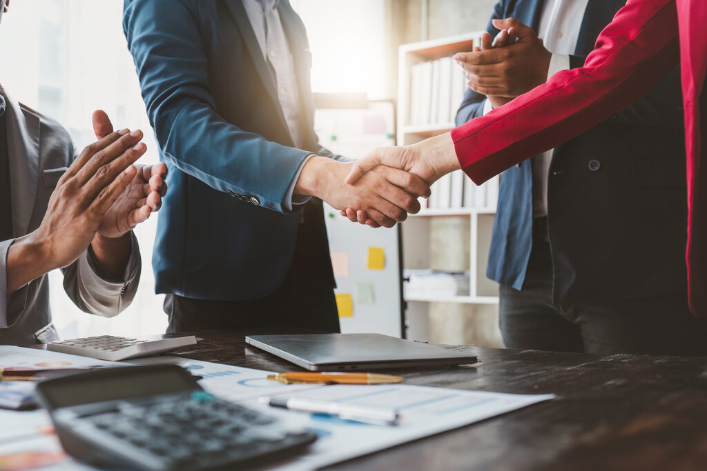 Business shaking hands. Successful businessmen handshaking after good deal. Finishing up meeting concept to hire supplemental labor for business.